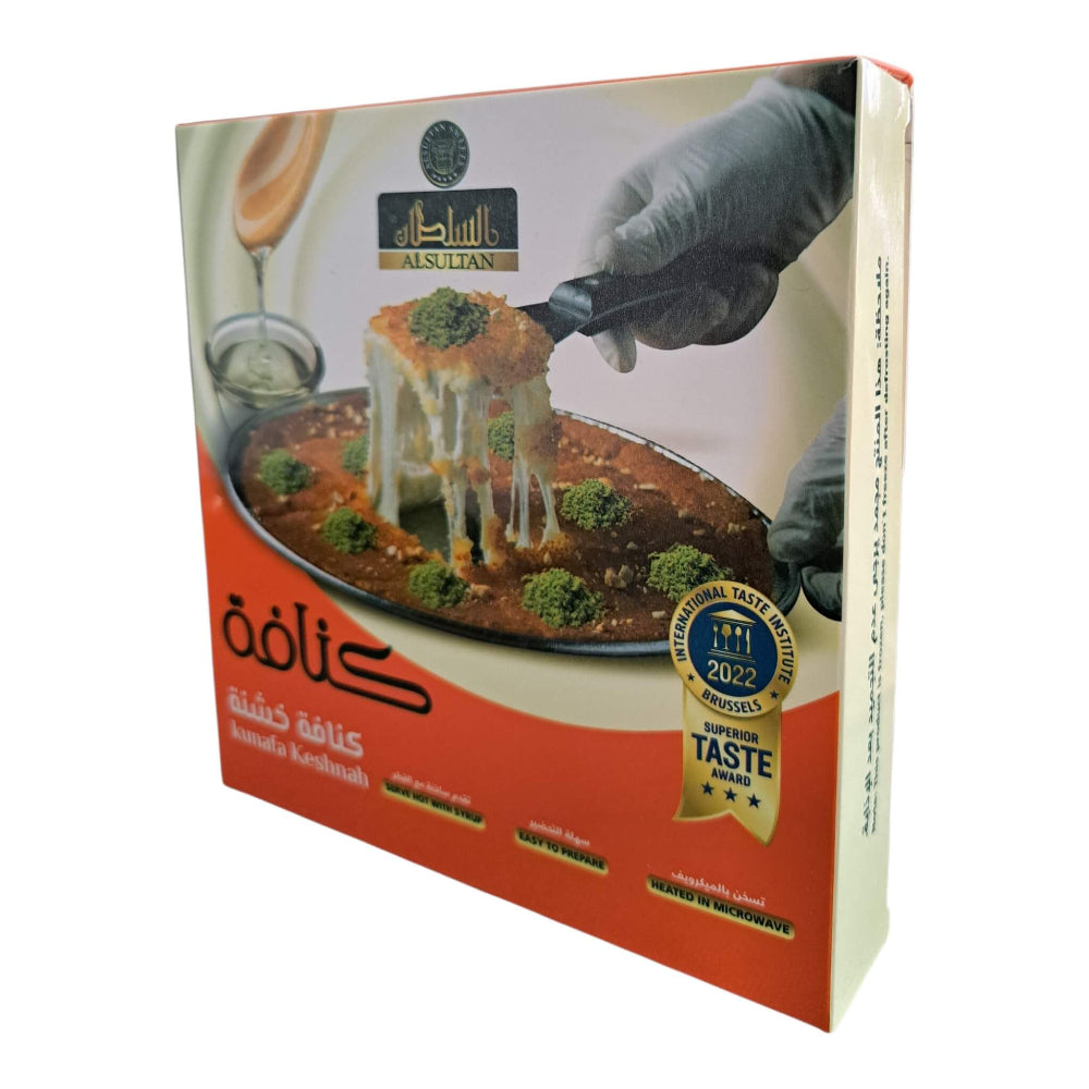 A boxed food product photographed on a plain white background. The package is a rectangular carton with a printed photo of a cheesy baked dish, gloved hands, and Arabic text.