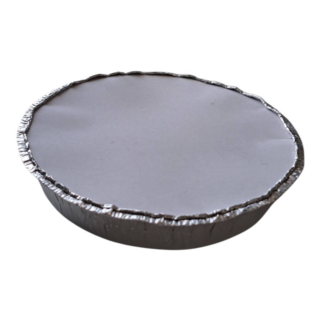 A round aluminum foil pie tin with a crimped edge, shown from a top-down angle on a plain white background.