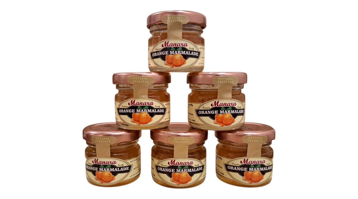 Five jars of Manava Orange Marmalade arranged in a pyramid stack on a plain white background.