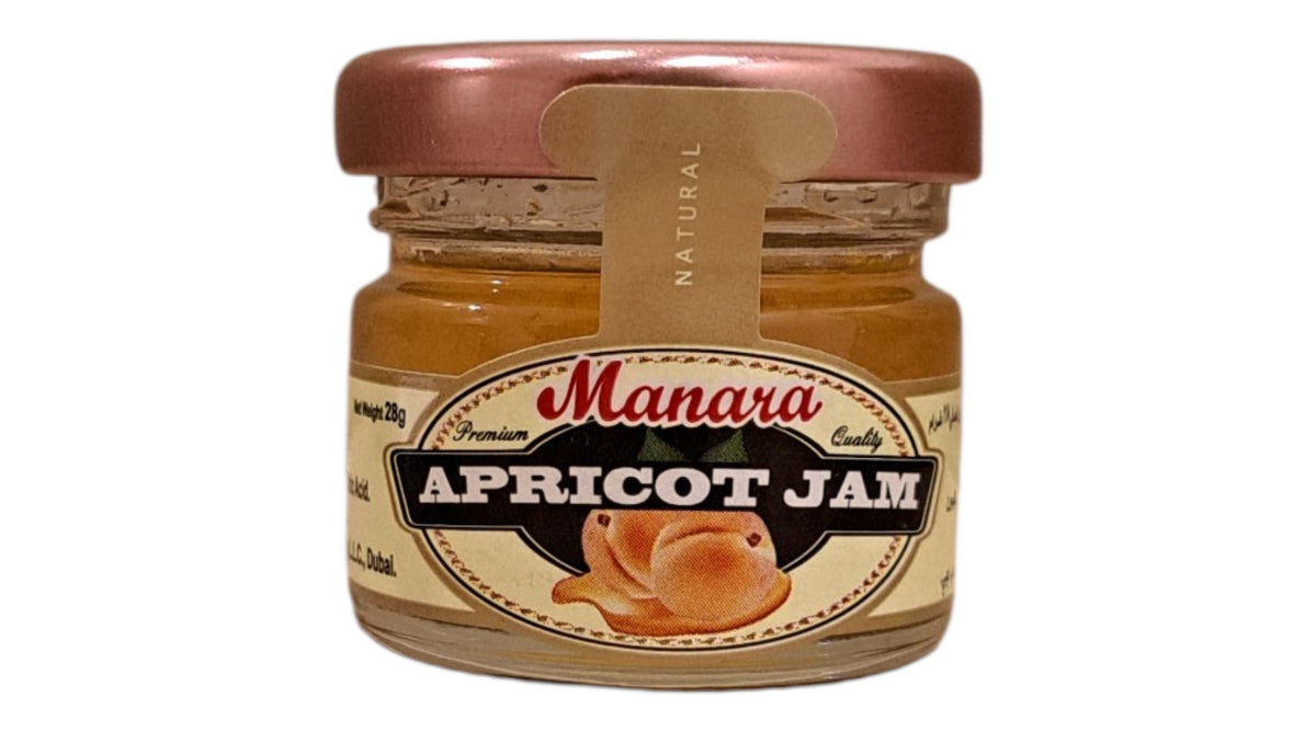 A glass jar of Manara Apricot Jam with a metallic rose gold lid and a cream-colored label, shown against a plain white background.