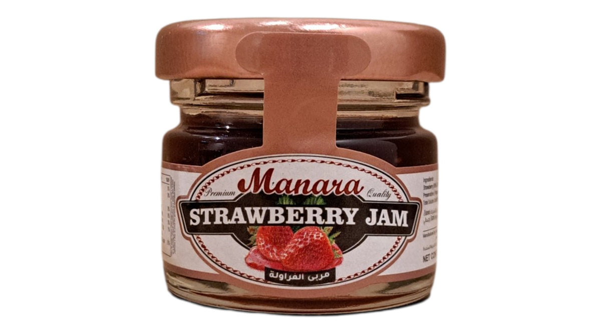 A glass jar of Manara Strawberry Jam with a copper-colored metal lid and a white label featuring red strawberries, set against a plain white background.