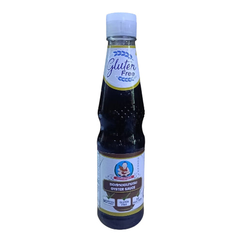 A bottle of gluten free oyster sauce with a white cap and white label, containing a very dark brown sauce, shown on a plain white background.