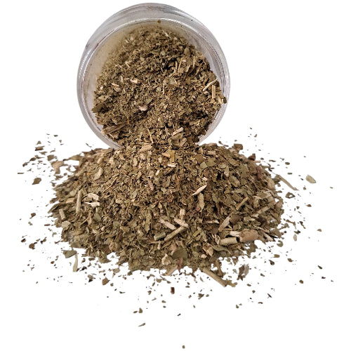 A clear plastic jar tipped on its side with a pile of dried, chopped green-brown herbal or botanical powder spilled out onto a white background.