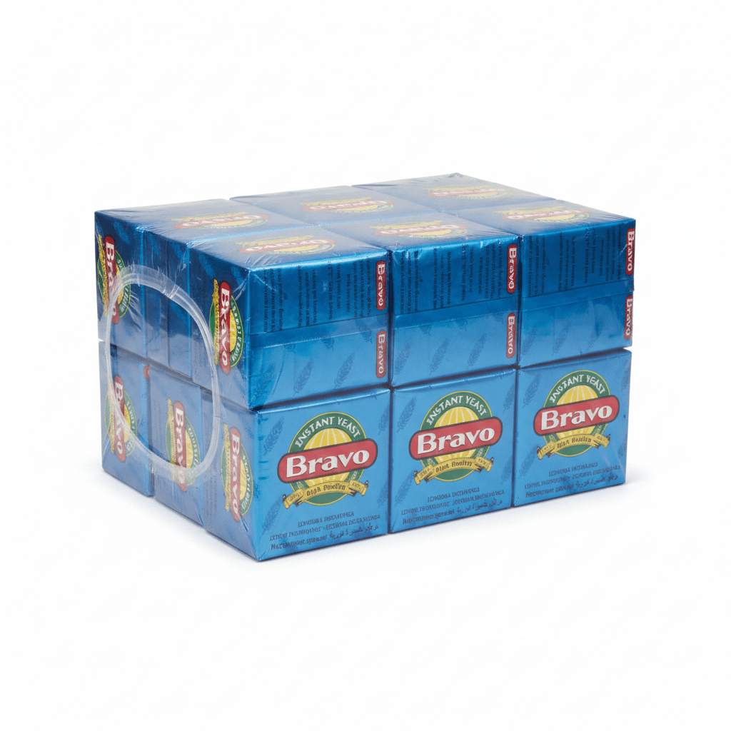 A 12-pack of Bravo Instant Tea in blue cardboard boxes wrapped together in clear plastic, with a clear plastic carry handle attached on the left side, set against a plain white background.