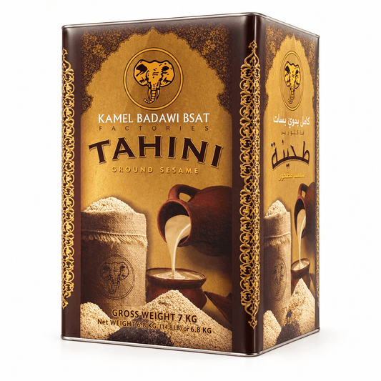 A 7 kg metal tin of Camel Badawi BSAT Tahini Ground Sesame, featuring a dark brown and gold design with an elephant logo and illustrations of sesame paste and a traditional pouring scene.