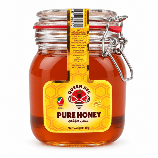 A 1kg glass jar of Queen Bee Pure Honey with a yellow label and metal clamp lid, shown on a white background.