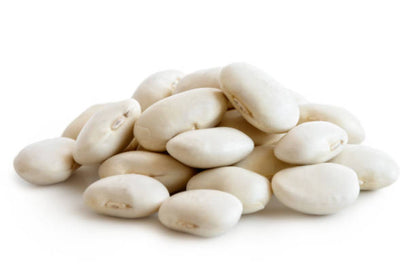 A pile of white kidney-shaped lima beans on a white background.